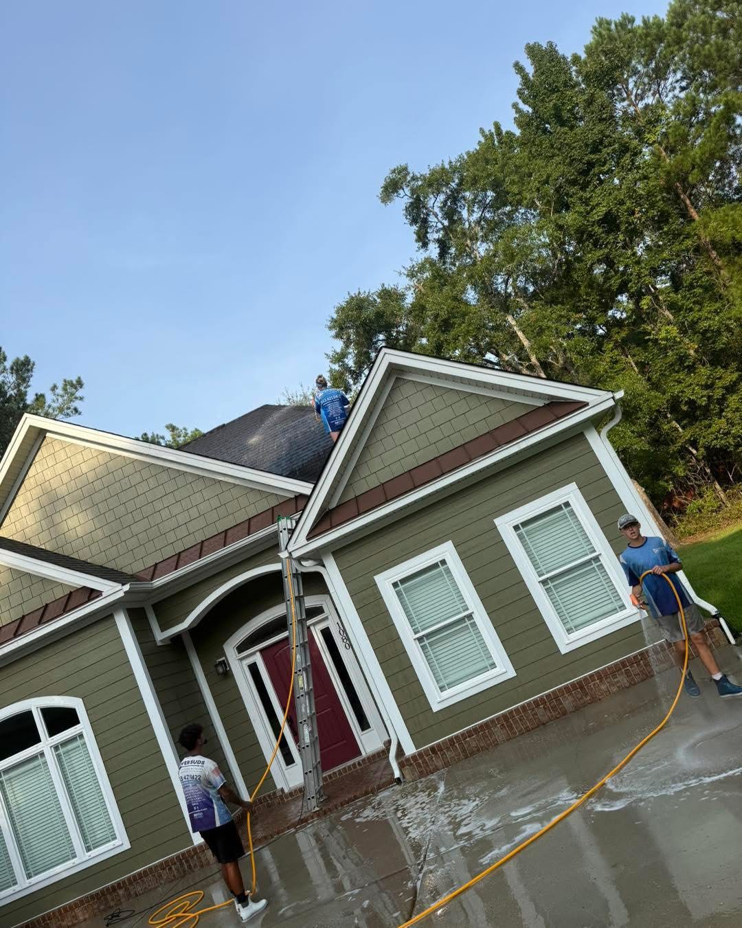 Power Suds crew soft washing a roof